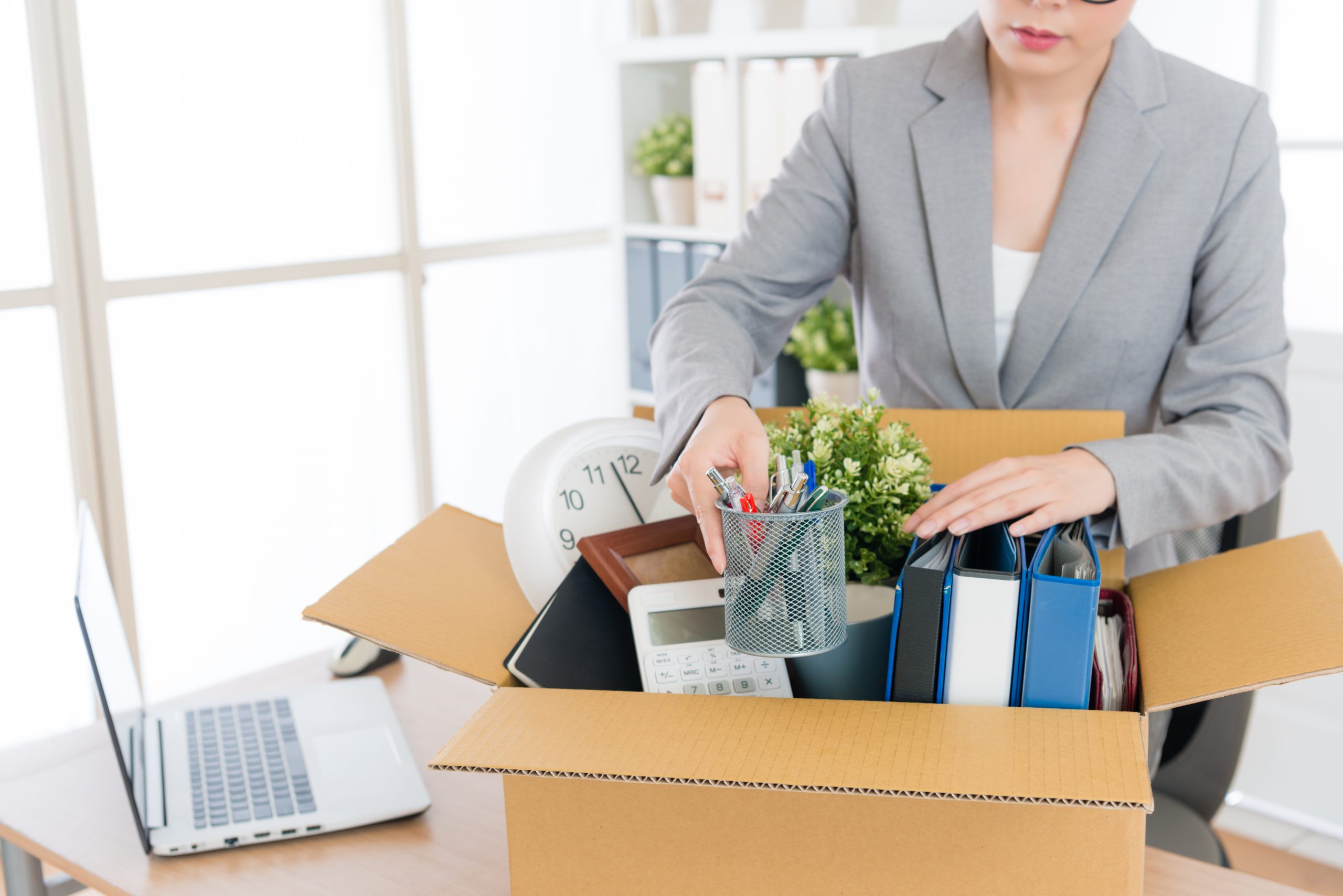 business woman packing personal company belongings