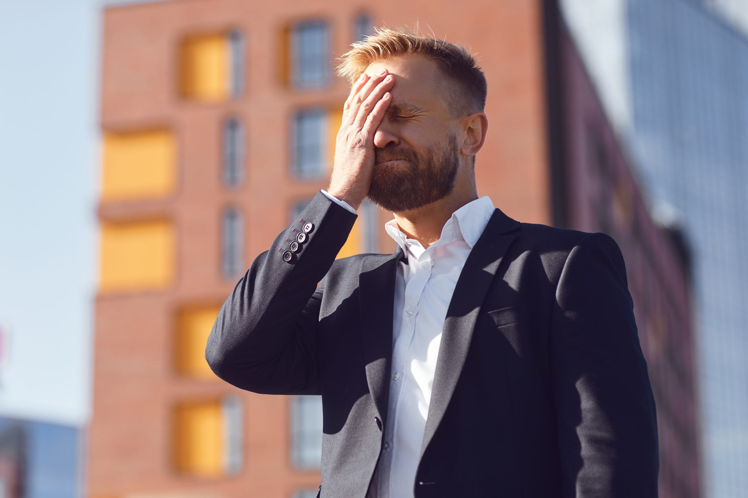 Sad man holding head in life transitions