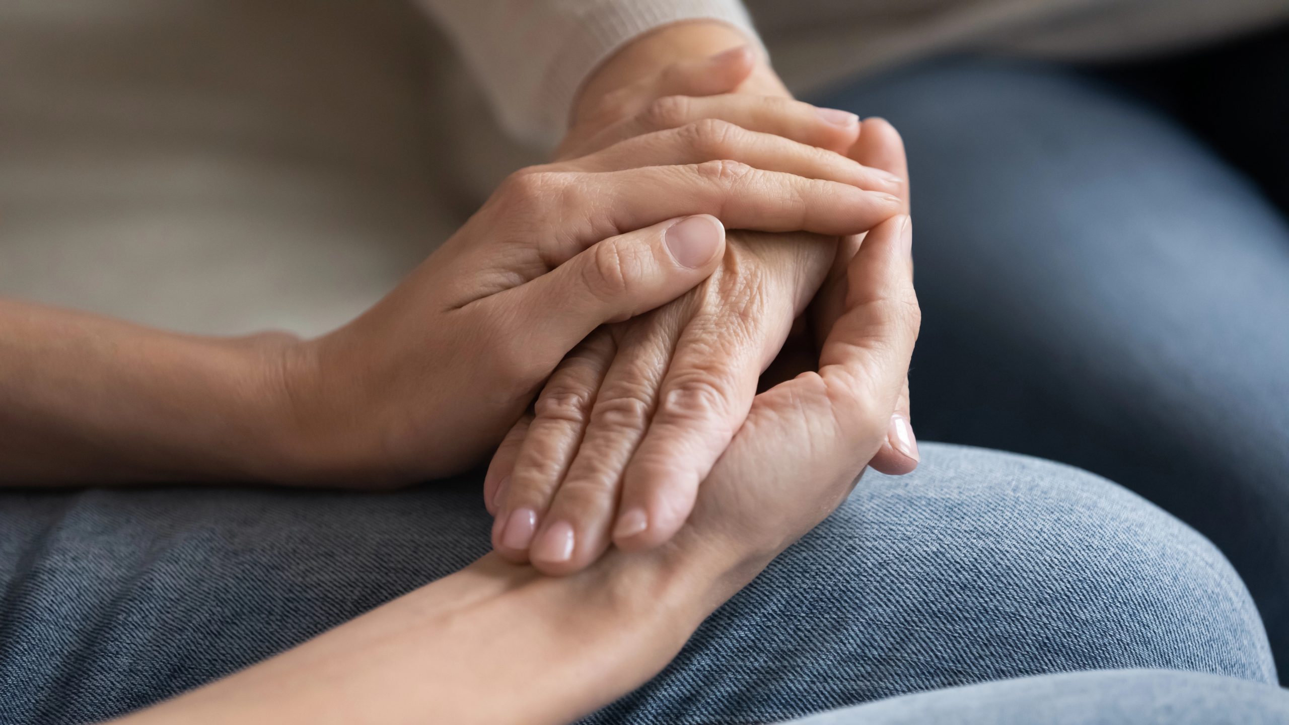 middle-age-daughter holding elders hands